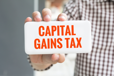 Who reports capital gains if a stock is owned jointly?