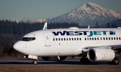 WestJet to charge $25 fee for first checked bag in economy fares